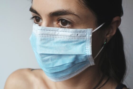 Primo piano di una donna con indosso una mascherina chirurgica